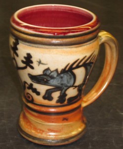 decorated mug with boar & oak tree design; 4.5 – 5” tall.